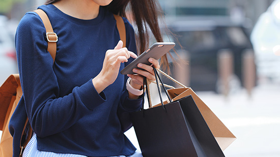 person holding phone and shopping