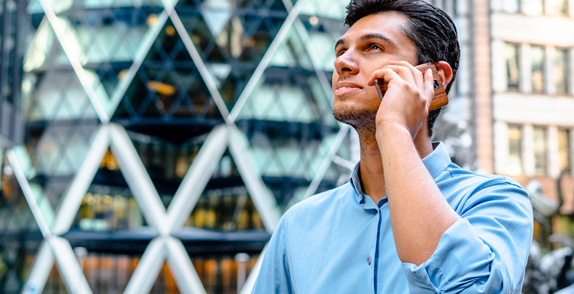 Business man on a mobile phone in a city