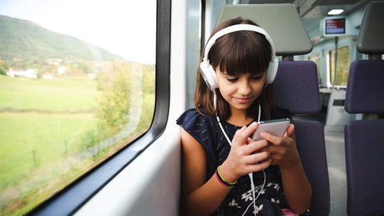 Teenager using phone on train
