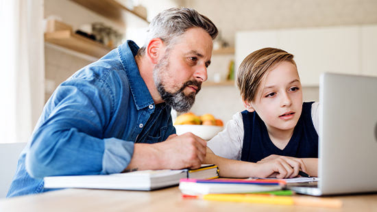 Father and son using laptop