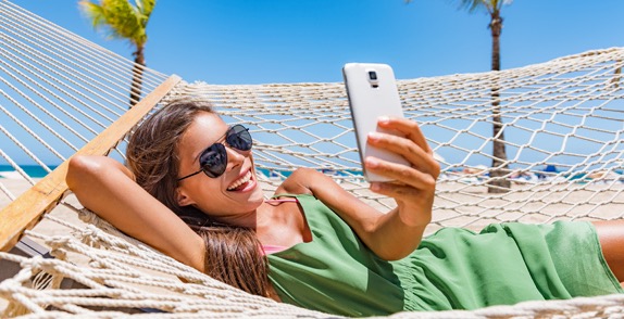 Woman using phone on beach