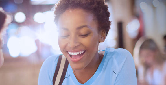 Woman smiling wearing a blue t-shirt