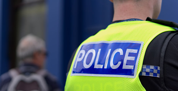 Back of Derbyshire Police officer with hi-vis waistcoat