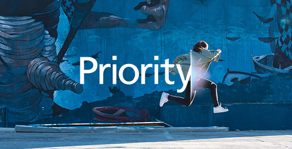 Woman jumping with Priority logo