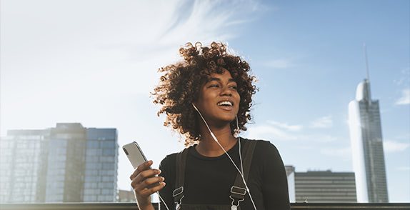 Woman with phone and headphones