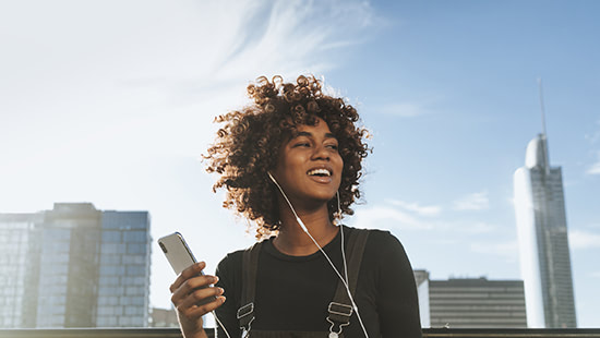 person holding a phone wearing headphones