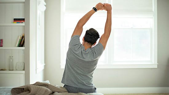 person stretching on a bed