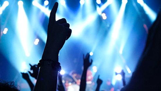 lights and hands in the air at a concert