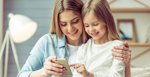 Mother and daughter looking at phone