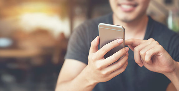 Man using an iphone to boost his productivity