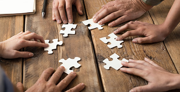 Hands holding puzzle pieces