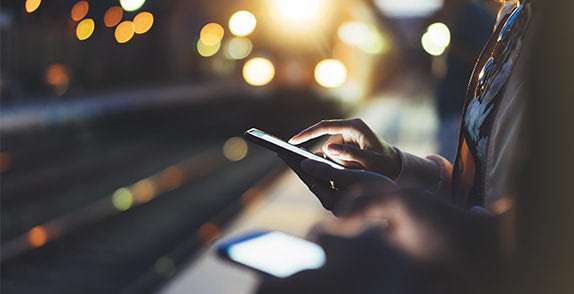 Person using a tablet at a train station