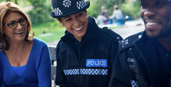 Surrey & Sussex Police officers laughing with a woman