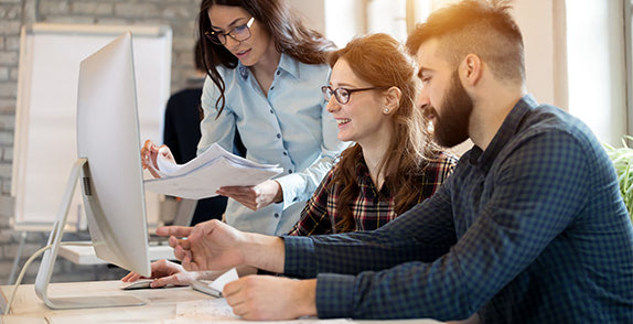 Group of people looking at a computer screen