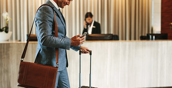 Man using his phone in an airport