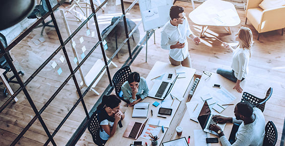 Staff working around a table in an office