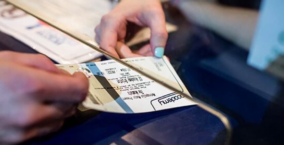 Customer collecting an O2 Academy priority ticket from a booth