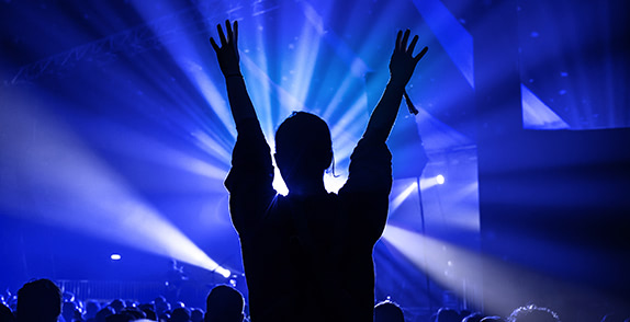 Person's silhouette against stage at a gig