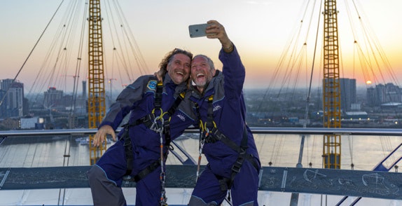 Two O2 customers taking a selfie at the top of the O2 having climbed Up
