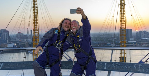 Two men taking a selfie on to of The O2