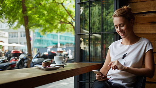 person on their phone in coffee shop