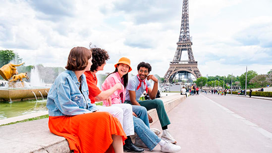 people sitting in front of the Eiffel Tower