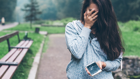 person holding broken phone