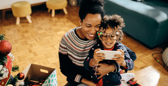 mother and son using a phone at christmas