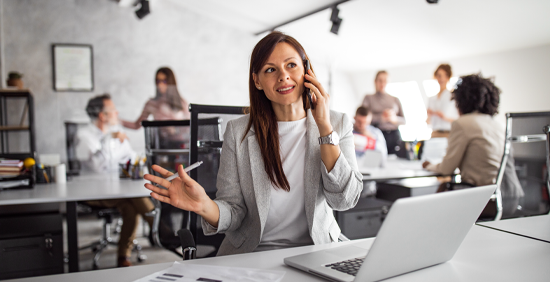 Businesswoman on phone in office environment using O2 Mobile Voice Solutions