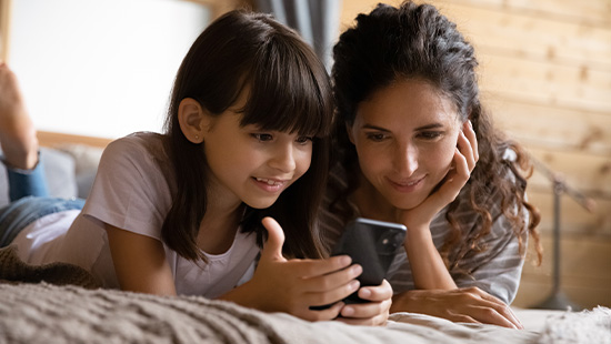 woman and child looking at a phone