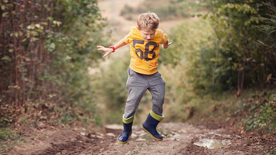 child jumping outside