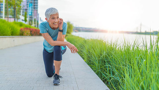 runner smiling by a river