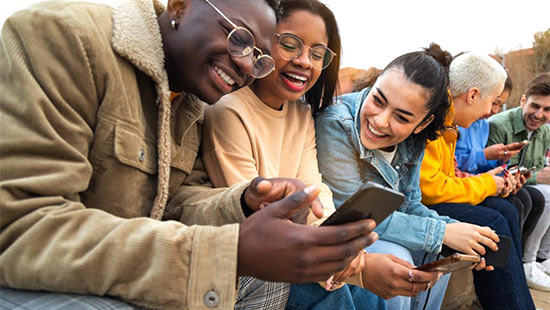 people sitting down looking at a phone