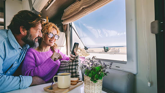 people in a caravan looking at a phone