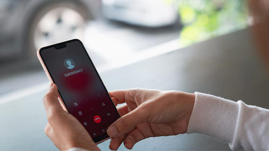 person holding a phone with an emergency call screen