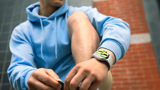 person crouched down with a smartwatch on their wrist