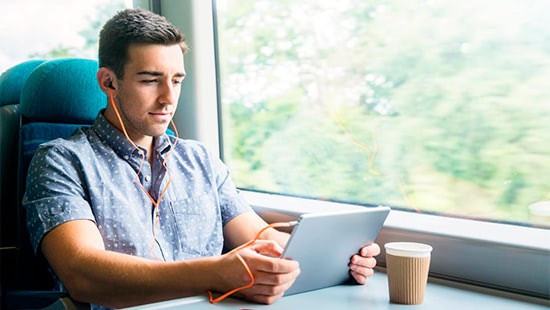 person on a train looking at a tablet