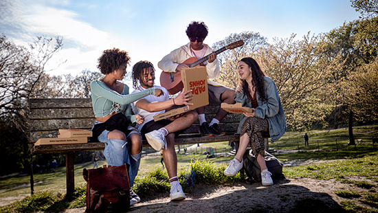 people sitting on a bench with food