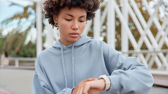 Teenage girl looking at her watch
